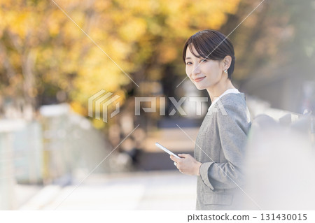 A woman using a smartphone A woman using a smartphone 131430015