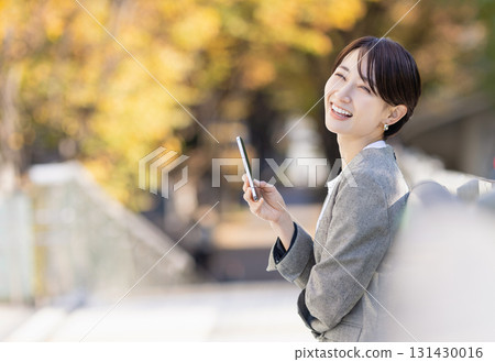 A woman using a smartphone A woman using a smartphone 131430016
