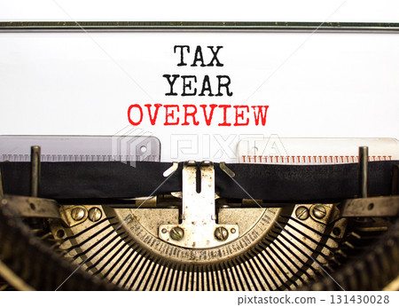 Tax year overview symbol. Concept words Tax year overview typed on beautiful old retro vintage typewriter. Beautiful white background. Business tax year overview concept. Copy space. Tax year overview symbol. Concept words Tax year overview typed on beautiful old retro vintage typewriter. Beautiful white background. Business tax year overview concept. Copy space. 131430028