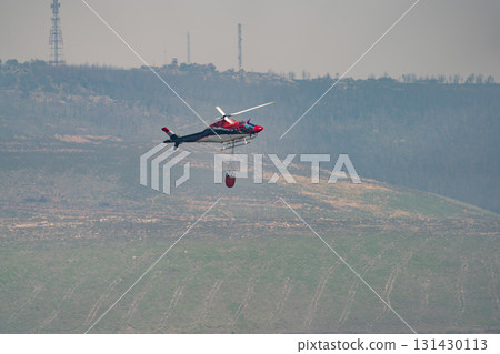 Helicopter Collecting Water for Firefighting Operations 131430113