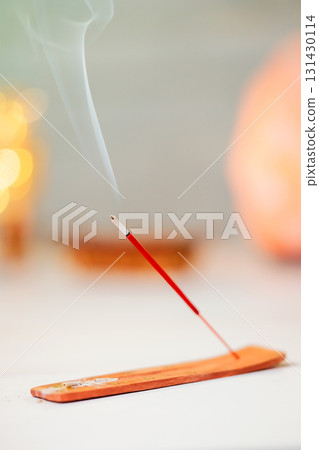 Burning scented stick burning on table Burning scented stick burning on table 131430114