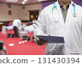 Doctor in gown uniform with stethoscope standing and holding chart in the quarantine room for the corona virus infected patients. 131430394
