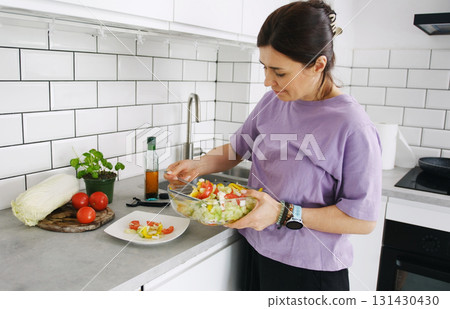 Woman Making Vegetable Salad For Lunch Arranges It On Plates 131430430