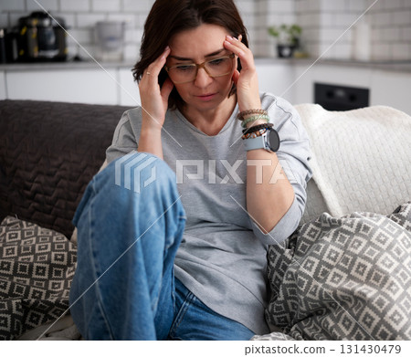 Young Woman Staying Home Sick With A Headache Young Woman Staying Home Sick With A Headache 131430479