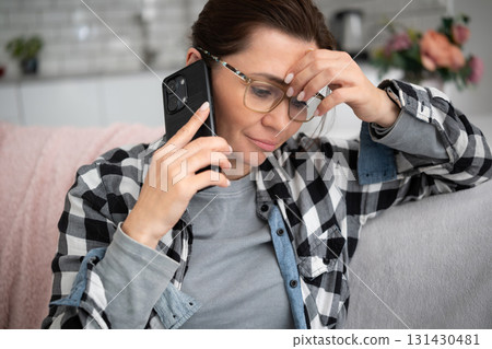 Woman Talking On The Phone Has An Unpleasant Conversation Woman Talking On The Phone Has An Unpleasant Conversation 131430481