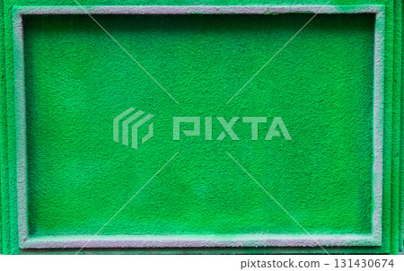Vibrant green textured background with a rectangular frame, ideal for design projects, showcasing a lively and fresh atmosphere with ample copy space for text or graphics 131430674