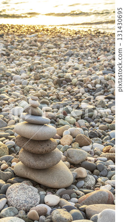Cairn made of pebbles on the sea shore. 131430695