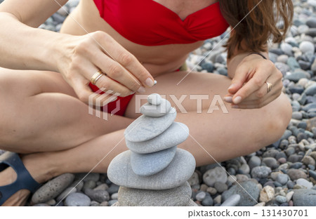 Cairn made of pebbles on the sea shore. 131430701