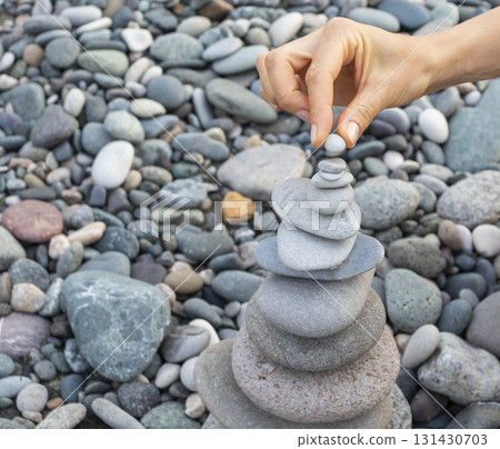 Cairn made of pebbles on the sea shore. 131430703
