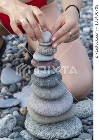 Cairn made of pebbles on the sea shore. 131430708