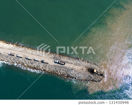 Constratruction of stone wall at green sea water Constratruction of stone wall at green sea water 131430946