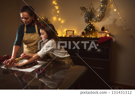 Mother And Daughter Bake Gingerbread And Decorate For Christmas In Cozy Home Kitchen 131431312