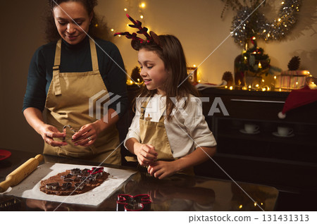 Mother And Daughter Baking Gingerbread Cookies Together In Cozy Christmas Kitchen 131431313