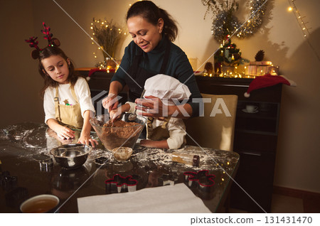 Joyful Mother Baking Gingerbread With Her Kids During Christmas Preparations At Home 131431470