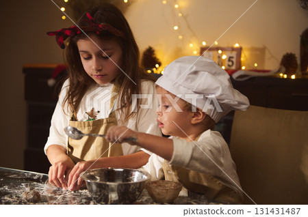 Two Kids Baking Gingerbread With Siblings In A Cozy Christmas Kitchen Scene 131431487