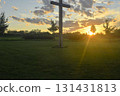 A great Christian cross in the landscape. A Christian cross highlighted by the sunset. The concept of religion and Christianity. 131431813