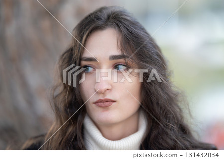 Woman looking aside with thoughtful expression Woman looking aside with thoughtful expression 131432034