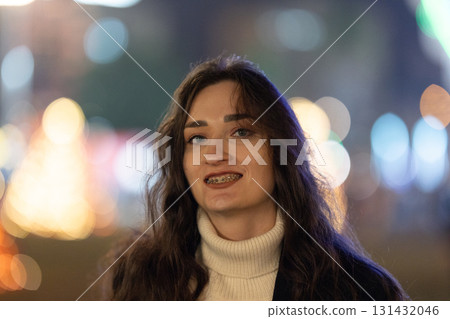 Young woman smiling with dental braces showing happiness 131432046