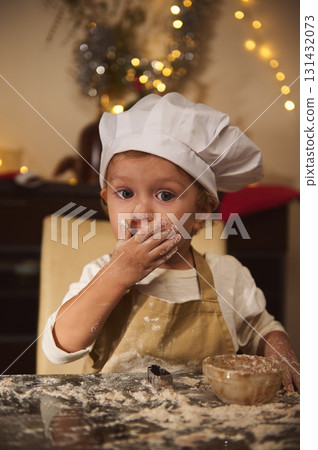 Adorable Child Chef Baking Gingerbread With Floury Hands During Christmas At Home Adorable Child Chef Baking Gingerbread With Floury Hands During Christmas At Home 131432073