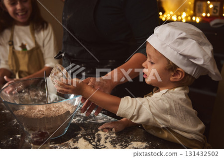 Young Child as Chef Helps Make Gingerbread Dough Alongside Family During Christmas Young Child as Chef Helps Make Gingerbread Dough Alongside Family During Christmas 131432502
