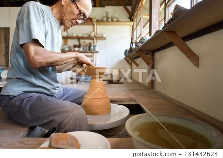 一名男陶工正在使用陶輪塑造一個器皿 131432623