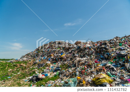 A massive mound of garbage sits in a rural area with clear skies, showcasing the pressing issue of waste management and pollution A massive mound of garbage sits in a rural area with clear skies, showcasing the pressing issue of waste management and pollution 131432782