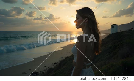 Woman enjoying sunset by the ocean at a picturesque beach with gentle waves and fluffy clouds in the background 131432843