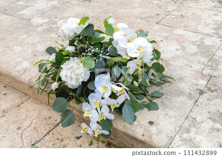 Roses orchids hydrangeas bouquet on vintage stairs Roses orchids hydrangeas bouquet on vintage stairs 131432899