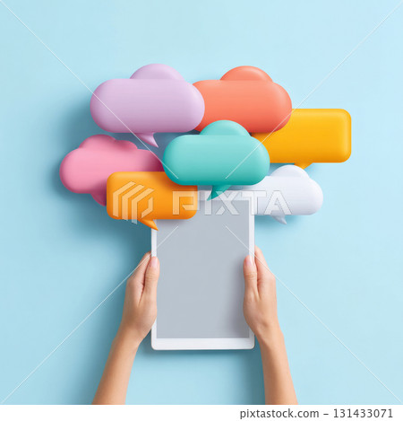 A person's hands holding a tablet displaying a blank screen, with various colorful speech bubbles floating above it. 131433071