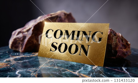 Elegant golden card with 'Coming Soon' text placed on marble surface beside natural stones Elegant golden card with 'Coming Soon' text placed on marble surface beside natural stones 131433120