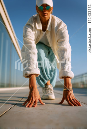 Low angle close-up of ultra plus-size East Asian woman in runner pose on rooftop under clear blue sky 131433381