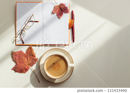 Autumn Flat Lay with Notebook, Coffee, Leaves and Eyeglasses 131433400