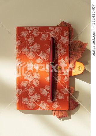 Autumn Notebook with Leaves and Pen on Light Background under Sun light 131433407