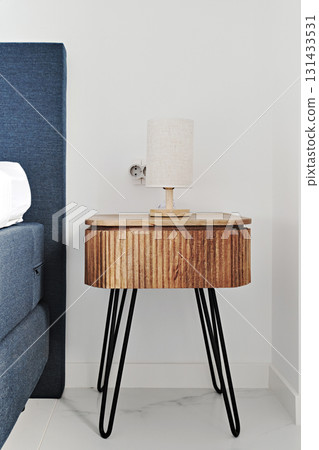 Modern wooden bedside table with lamp Modern wooden bedside table with lamp 131433531