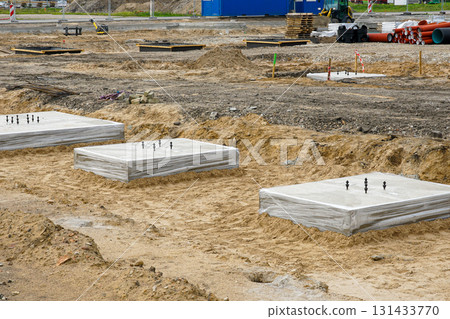 Concrete foundation blocks with anchor bolts at building construction site groundwork Concrete foundation blocks with anchor bolts at building construction site groundwork 131433770