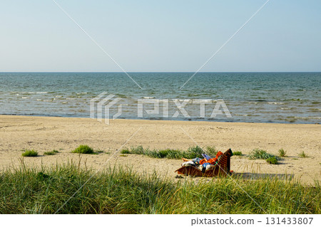 Relaxing on a sandy Baltic Sea beach with gentle waves, grassy dunes, and peaceful summer vibe Relaxing on a sandy Baltic Sea beach with gentle waves, grassy dunes, and peaceful summer vibe 131433807