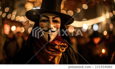 A person wearing a Guy Fawkes mask and a black hat stands in a crowd at night. The background features warm bokeh lights and a festive atmosphere 131434060