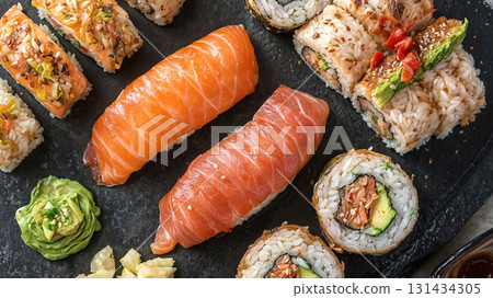 Assorted sushi rolls and nigiri with salmon, tuna, rice, avocado and wasabi on black stone plate, authentic Japanese cuisine, gourmet seafood dish, traditional Asian food served for elegant dining Assorted sushi rolls and nigiri with salmon, tuna, rice, avocado and wasabi on black stone plate, authentic Japanese cuisine, gourmet seafood dish, traditional Asian food served for elegant dining 131434305