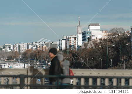 Tourists walking on a bridge and enjoying the view of Budapest, Hungary Tourists walking on a bridge and enjoying the view of Budapest, Hungary 131434351