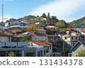 Traditional Kyperounta village houses climbing Troodos mountainside in Cyprus 131434378