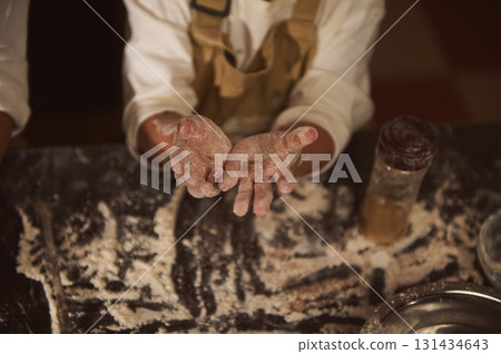 Baker Hands With Flour-Dusted Hands Preparing Gingerbread In Cozy Home Kitchen 131434643