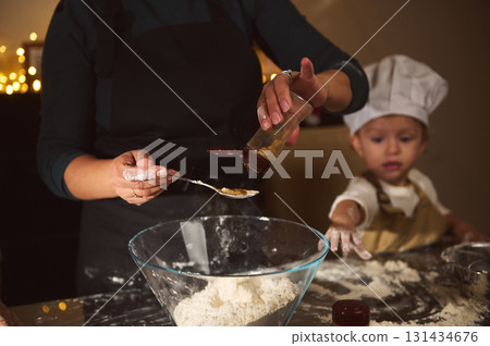 Happy Family Baking Gingerbread Together: Mother and Two Kids Craft Christmas Treats in Cozy Kitchen 131434676
