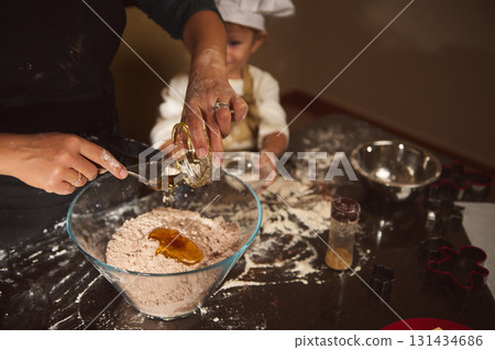 Tender Moment Of Baking With Mom And Child In A Cozy Kitchen 131434686
