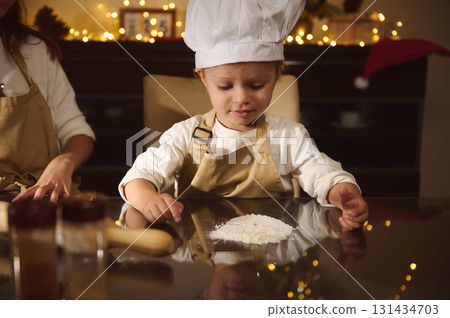 Young Child Chef Baking Christmas Cookies With Family In Cozy Kitchen Decor Young Child Chef Baking Christmas Cookies With Family In Cozy Kitchen Decor 131434703