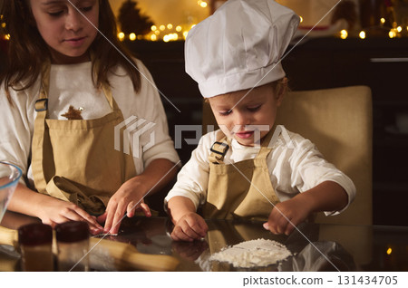 Little Chefs Bake Holiday Gingerbread As Family Gathers For Christmas Joy Little Chefs Bake Holiday Gingerbread As Family Gathers For Christmas Joy 131434705