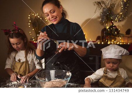 Joyful Mother Baking Gingerbread With Kids During Christmas At Home 131434749