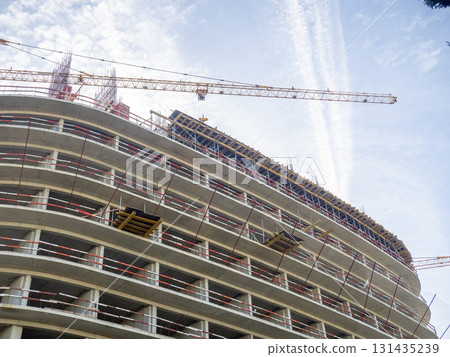 Construction of a modern high-rise building. Sides on the floors. Concrete frame of a building under construction.  Construction in progress 131435239