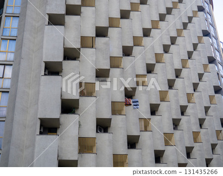 Balconies of unusual shape. Architecture background. Uneven house. High-rise building. Balconies of unusual shape. Architecture background. Uneven house. High-rise building. 131435266