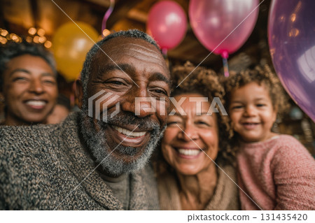 Happy family members smiling together surrounded by balloons during a birthday celebration Happy family members smiling together surrounded by balloons during a birthday celebration 131435420