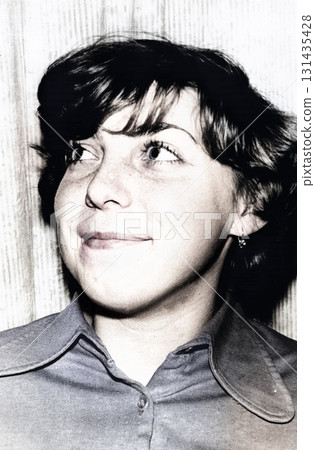 A vintage portrait of a sweet, smiling eighteen-year-old girl before the school year. Retro photo from 1978. 131435428